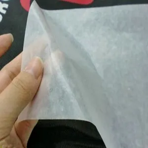 Detail shot of translucent white food-grade wax paper showing texture and thickness.