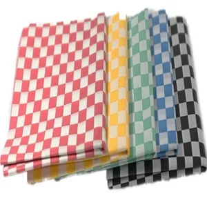 Close-up detail of various colors of checkered greaseproof wax paper for food packaging