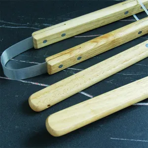 Close-up view of the durable oak wood handles and stainless steel joints on outdoor BBQ tool set