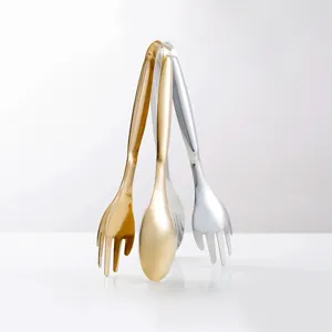 Close-up of gold and silver stainless steel food tongs with elegant metallic finish
