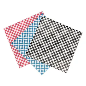 Close-up detail of checkered deli paper sheets in red, blue, and black for food wrapping.