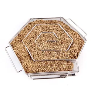 Detailed macro view of a hexagonal cold smoke generator filled with wood chips for BBQ