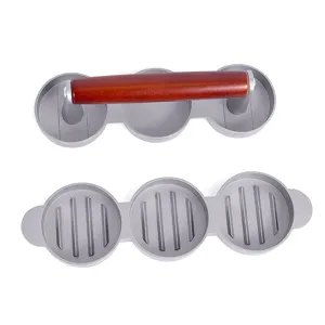 Close-up of a 3-cavity stainless steel hamburger patty press with wooden handle