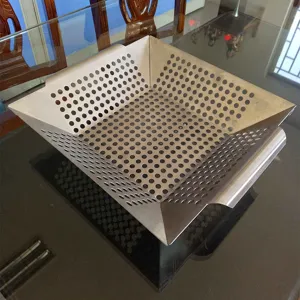 Stainless steel square BBQ grill basket with perforated holes for outdoor cooking vegetables.