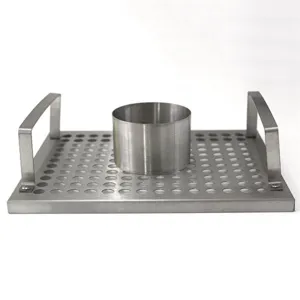 Close-up detail of a stainless steel BBQ chicken roaster rack with a perforated base tray