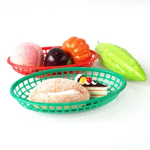 Detail view of colorful plastic oval fast food baskets containing realistic fake food props