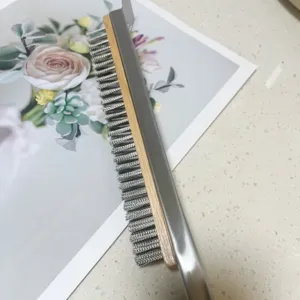 Detailed macro view of heavy-duty wire pizza oven brush with durable wooden handle