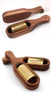 Detailed view of the gold titanium-plated stainless steel blade and wooden cheese grater