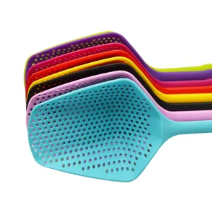 Vibrant set of colorful perforated plastic kitchen scoops for straining and serving food