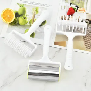 Set of white pizza lattice cutter, dough docker, and stainless steel roller for baking