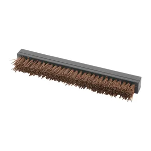 Detailed view of the dense coconut fiber bristles of a pizza oven cleaning brush