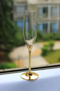 Elegant champagne flute with gold-plated metal stem and crystal accents for wedding gifts