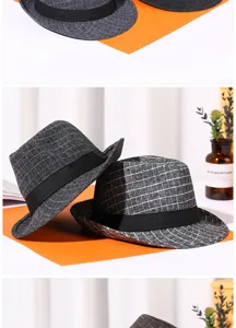 Close-up of grey checkered fedora hats with black ribbons in a vintage studio setting.