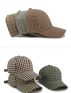 Detail view of various houndstooth pattern baseball caps with classic checkered texture.
