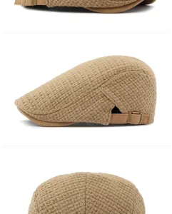 Detail of the beige knitted texture and side adjustable strap on a retro flat cap.