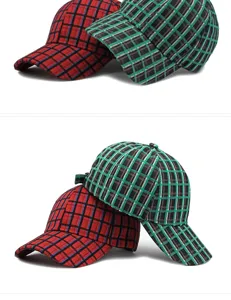 Close-up of red and green plaid baseball caps for sun protection on white background