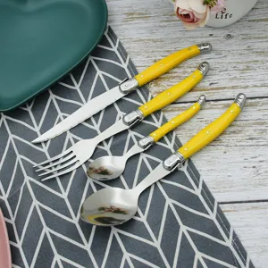 Detailed view of yellow bee-themed cutlery set including knife, fork, and spoons