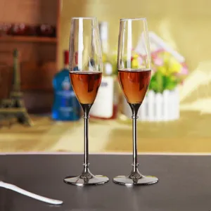 Pair of elegant crystal champagne glasses with silver metal stems for wedding gift sets.