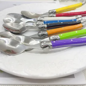 Close-up of stainless steel dessert spoons with vibrant colorful plastic handles