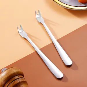 Two 304 stainless steel BBQ meat forks with minimalist handle design on warm background