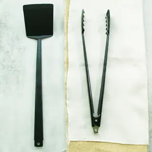 Detailed view of 2-piece black BBQ tool set including long-handled spatula and tongs