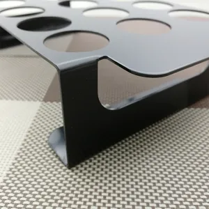 Close-up of durable 18-hole black metal chili and chicken leg grill rack for BBQ