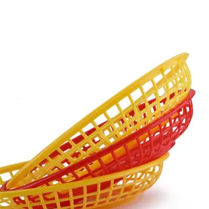 Stack of vibrant red and yellow plastic lattice baskets for fast food and desktop storage