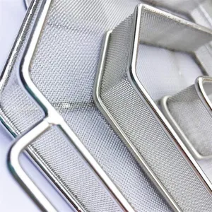 High-quality close-up macro detail of stainless steel mesh on hexagonal BBQ smoker box.