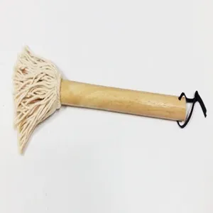 Close-up detail of a BBQ oil brush featuring a wooden handle and white cotton mop head