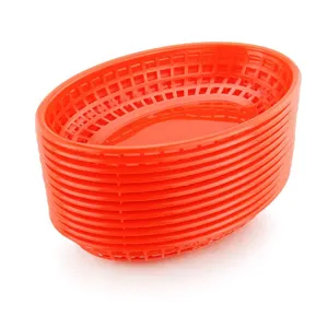 Detailed view of stacked red plastic oval mesh fast food baskets for restaurant use