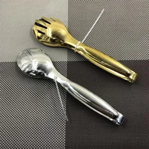 Detail view of gold and silver stainless steel food tongs for BBQ and serving