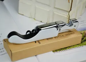Detailed view of a white seahorse-style wine bottle opener on a kraft paper box