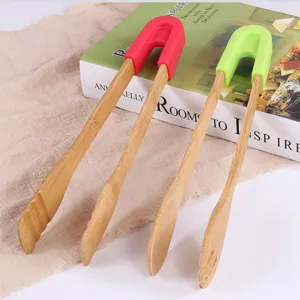 Macro detail of wooden food tongs with colorful silicone grips for BBQ and baking.