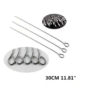 Macro detail of 30cm stainless steel BBQ skewers with looped handles and sharp tips.