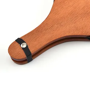 Close-up detail of a wooden manual bellows for BBQ fire starting and outdoor camping.