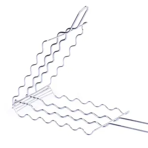 Macro view of stainless steel wavy wire BBQ grilling basket for outdoor sausage cooking
