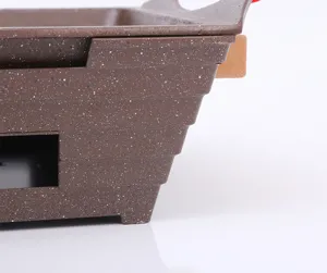 Detail van de Maifan steencoating en de getrapte zijstructuur van de rechthoekige grill