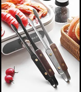 Detailed view of 304 stainless steel food tongs with elegant walnut wood handles