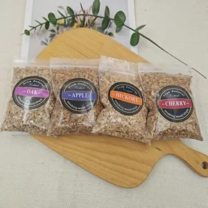 Detailed view of four flavors of wood chips for smoking cocktails in labeled bags.