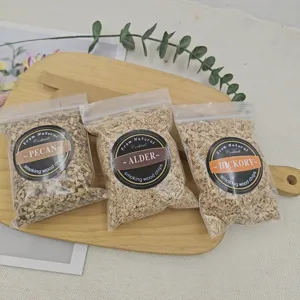 Detailed view of Pecan, Alder, and Hickory smoking wood chip bags for gourmet cocktails