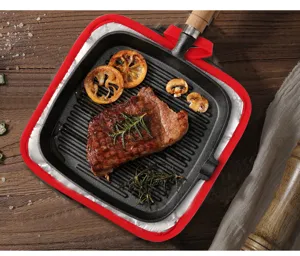 Red-bordered quilted pot holder pad protecting a wooden table from a hot cast iron grill pan