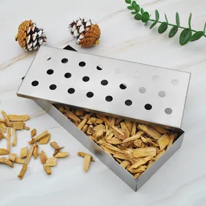 Detail view of a stainless steel BBQ smoker box filled with premium natural wood chips