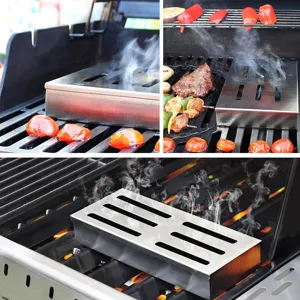 Close-up view of a stainless steel BBQ smoker box emitting smoke on an active outdoor grill.
