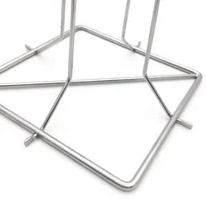 Close-up detail of the stainless steel base and folding joints of a BBQ chicken rack.