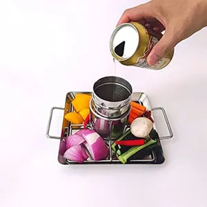 Detail of stainless steel beer can chicken roaster with liquid pouring into the holder