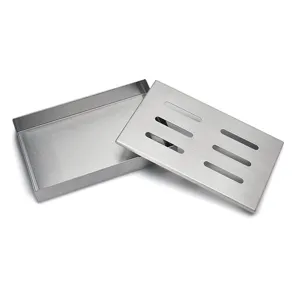 Detail of a brushed stainless steel smoker box with a slotted lid for outdoor BBQ grilling