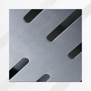 Macro detail showing the brushed metal texture and vent holes of a stainless steel smoker box