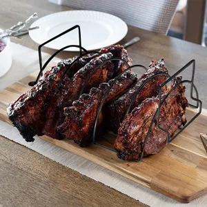 Close-up of a black non-stick steel rib rack holding grilled ribs on a wooden board