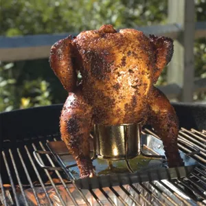 Detailed view of a stainless steel beer can chicken roaster rack on an outdoor grill