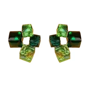 Close-up of elegant green cubic crystal stud earrings with a stylish geometric design.